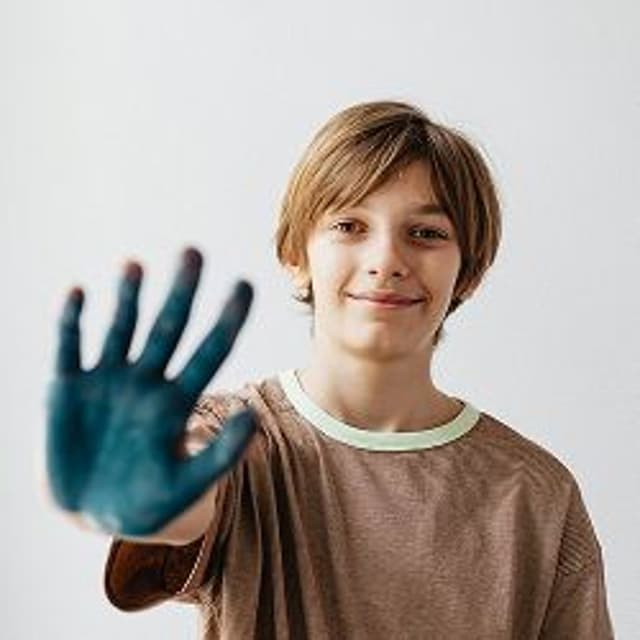 kid playing with paint