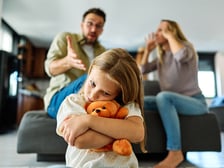 An unhappy girl experiencing unhealthy family dynamics as her parents argue