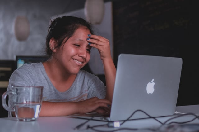 teen girl smiling during her online therapy session