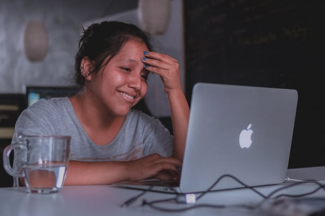 teen girl smiling during her online therapy session 