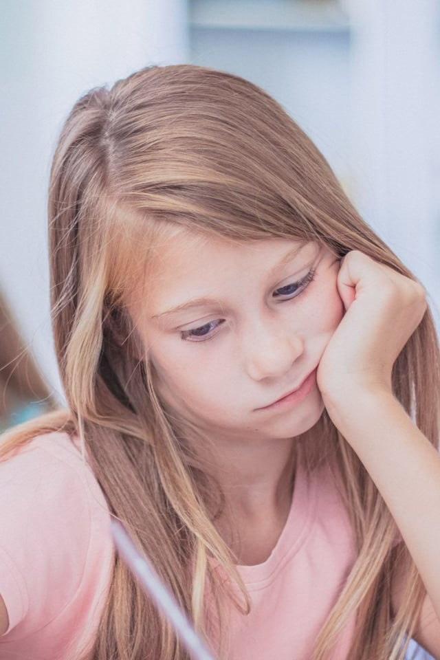 young girl sad at school