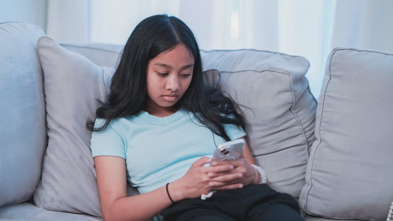 Young girl doom scrolling on her phone