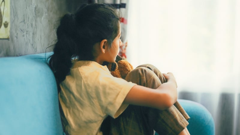 Young girl staring out the window