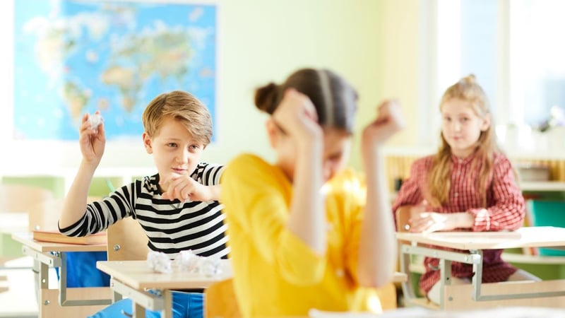 Angry child misbehaving at school