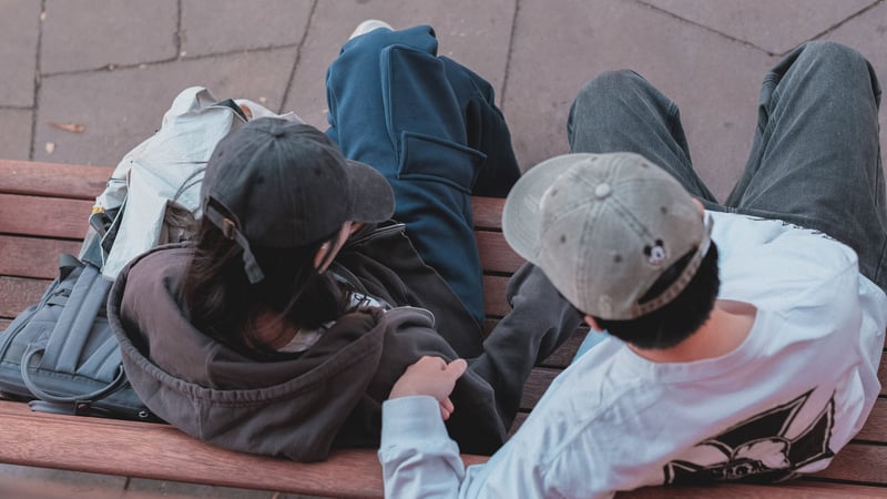 Teen couple talking on a bench