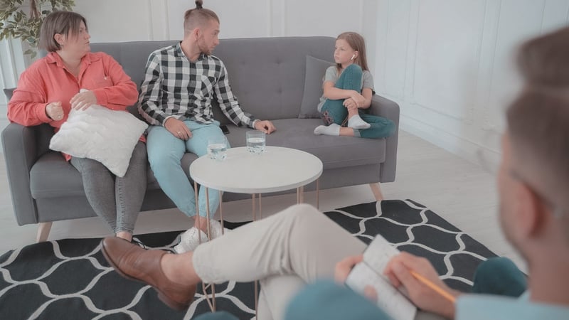 Family on a couch in a family therapy session