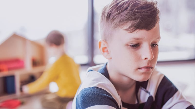 Kid dealing with trauma sitting alone