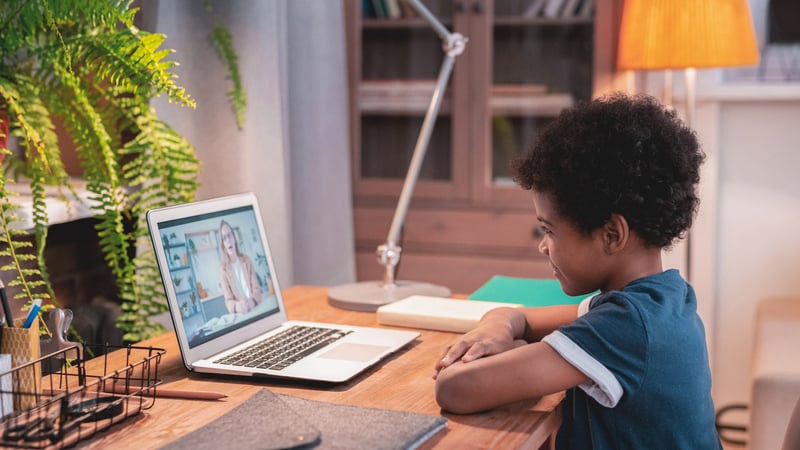 Kid doing online therapy on a laptop