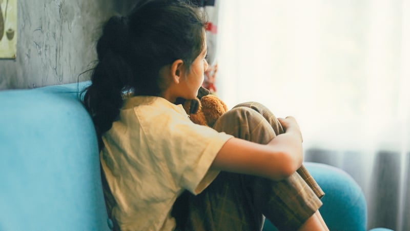 Young girl staring out the window