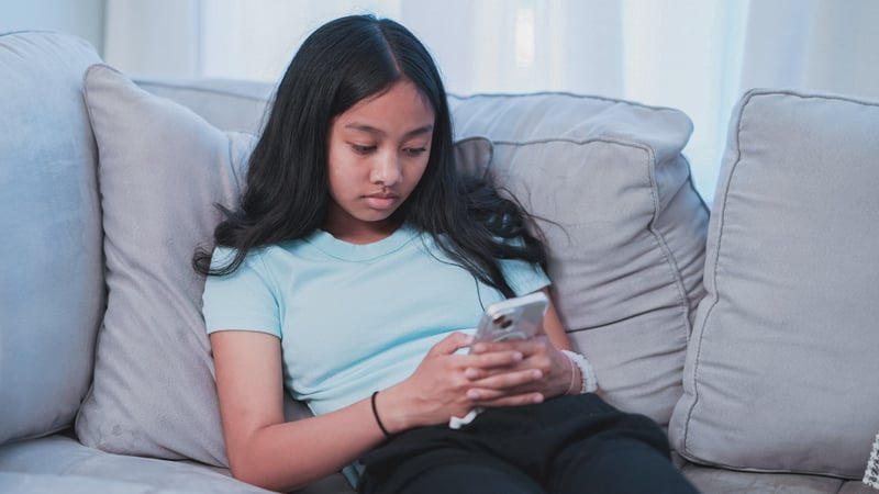 Young girl doom scrolling on her phone