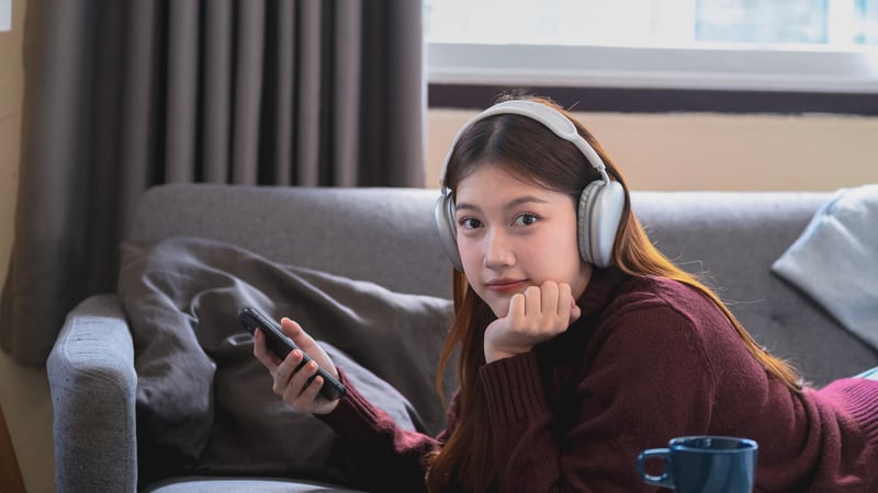 Teen girl listening to music and playing on her phone