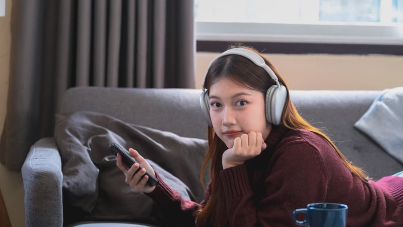Teen girl listening to music and playing on her phone