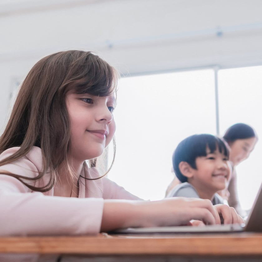 Young girl in the classroom with other students