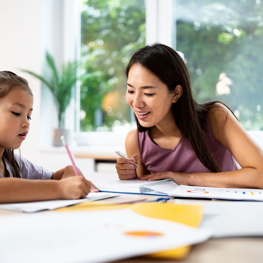 kid studying with teacher