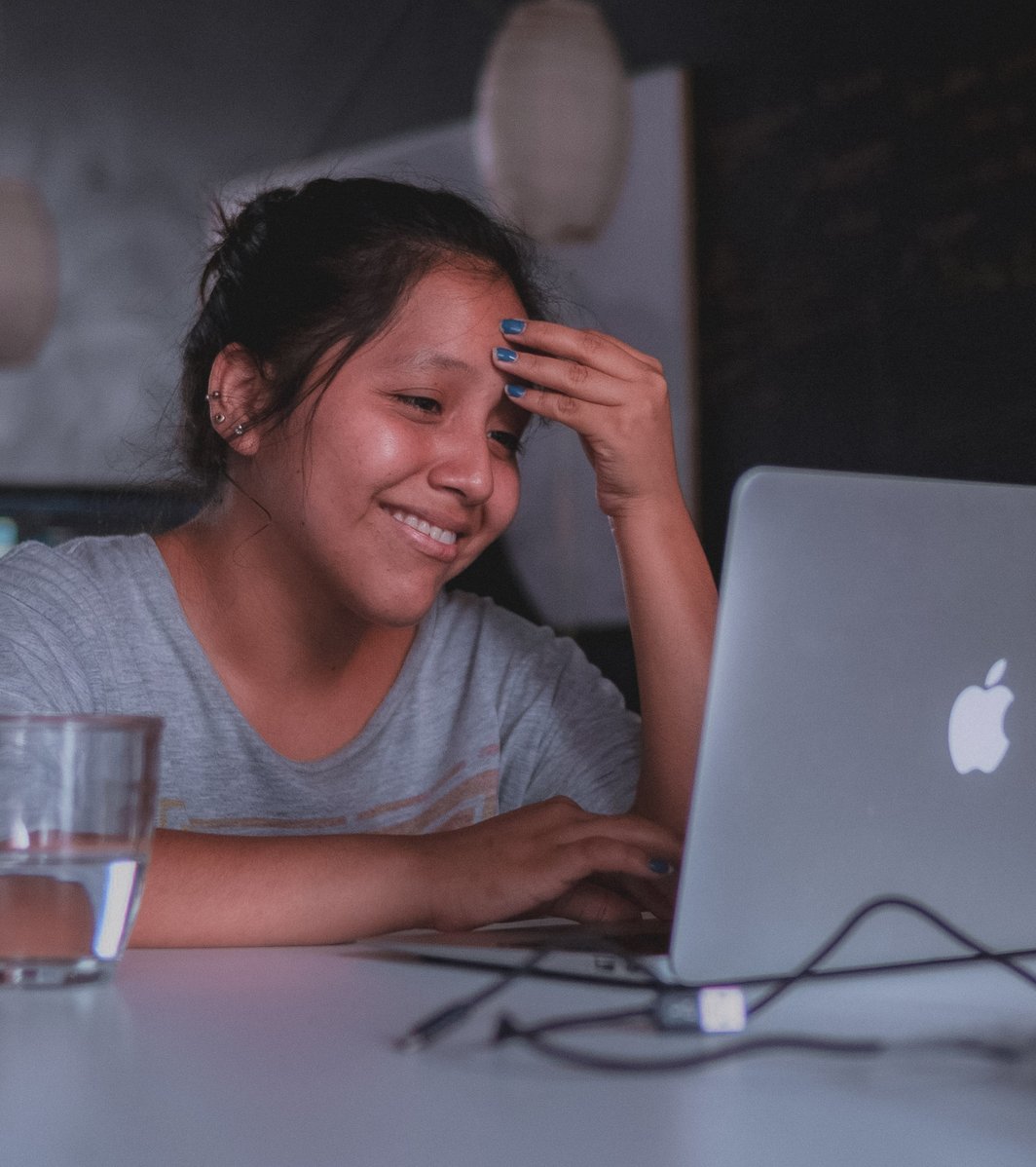teen girl smiling during her online therapy session