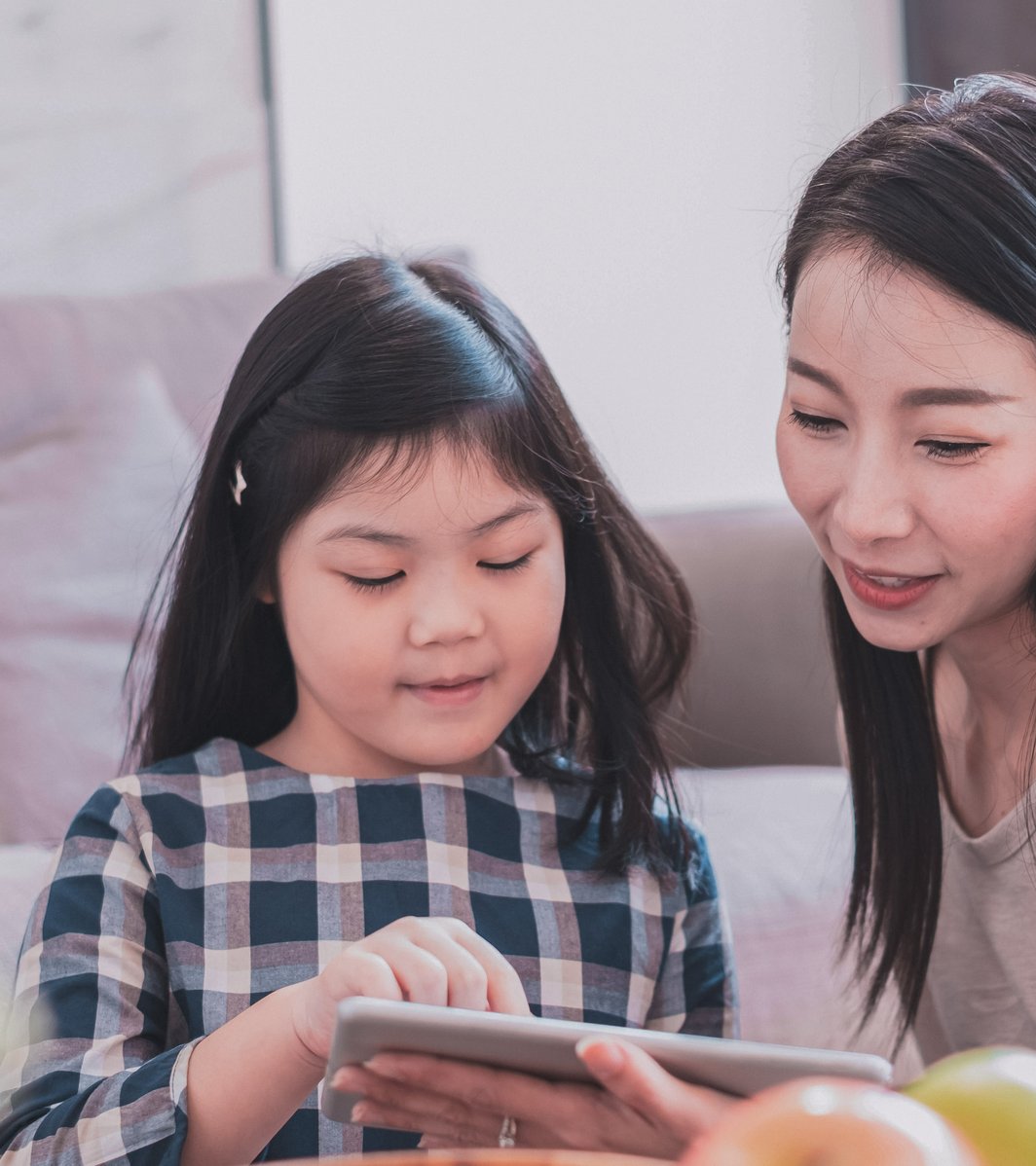 Daughter and mom playing together on an iPad
