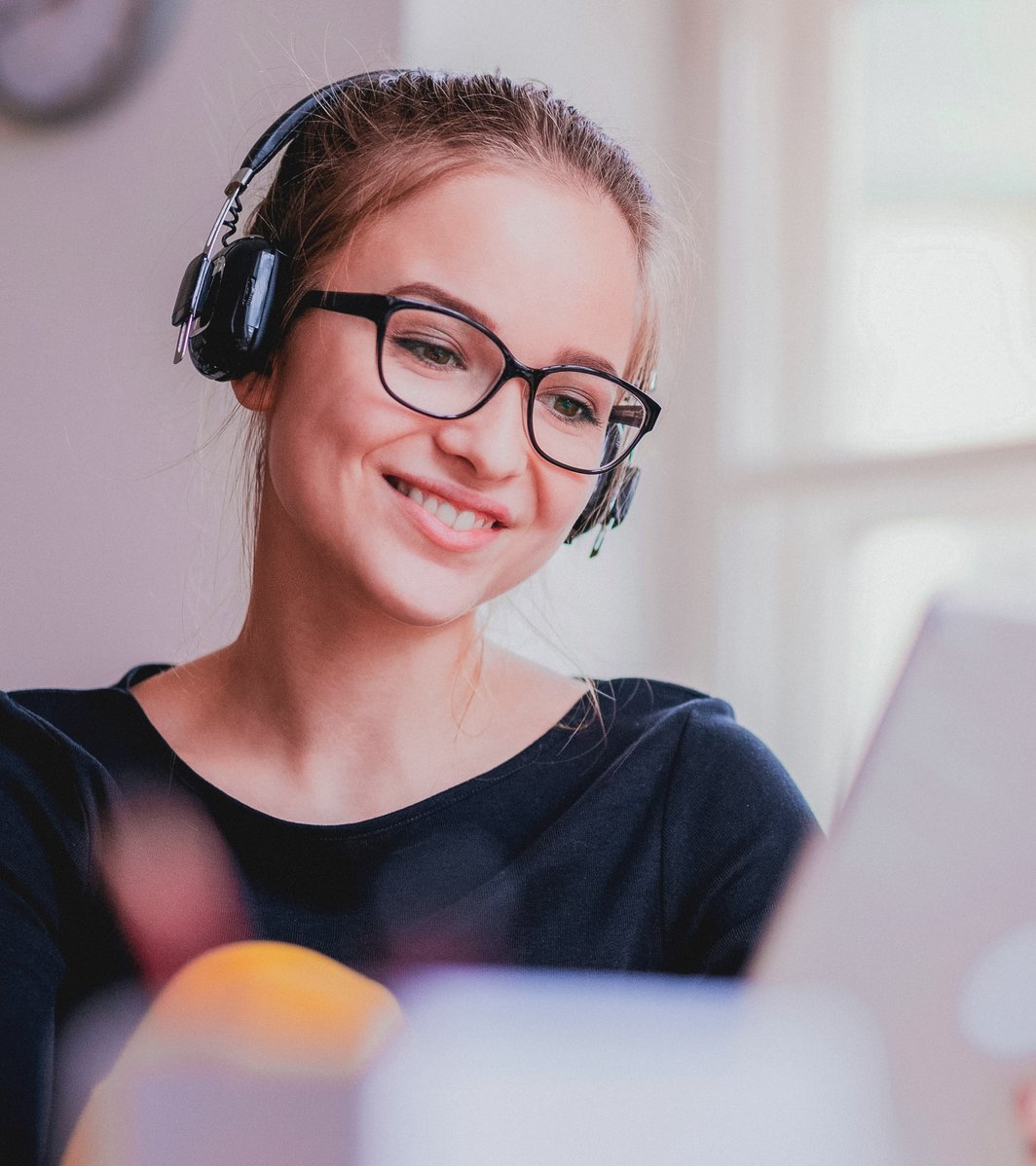 Young girl with headphones on our tablet