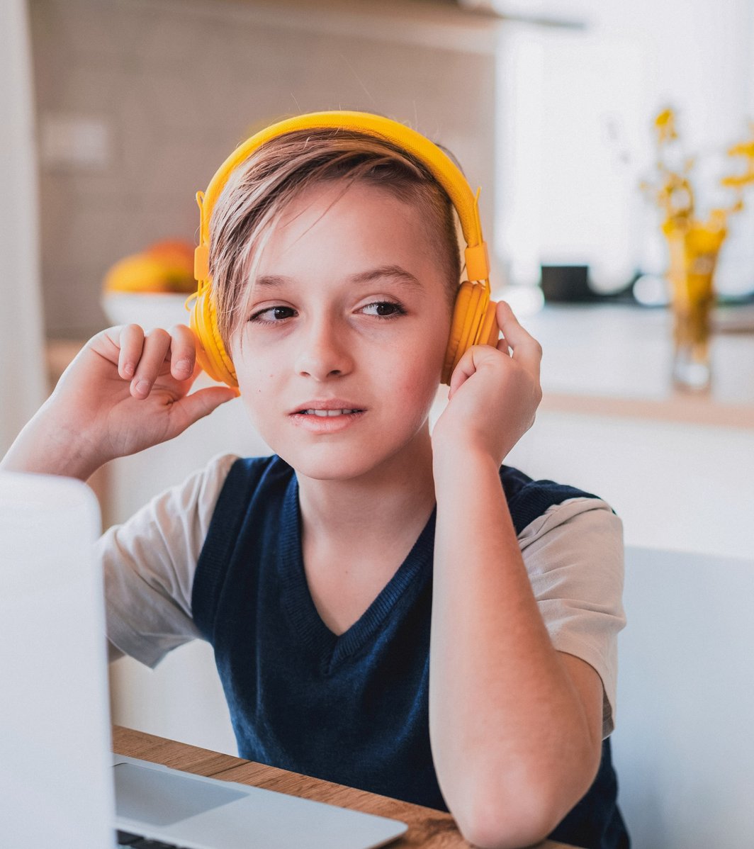 Young boy with yellow headphones on