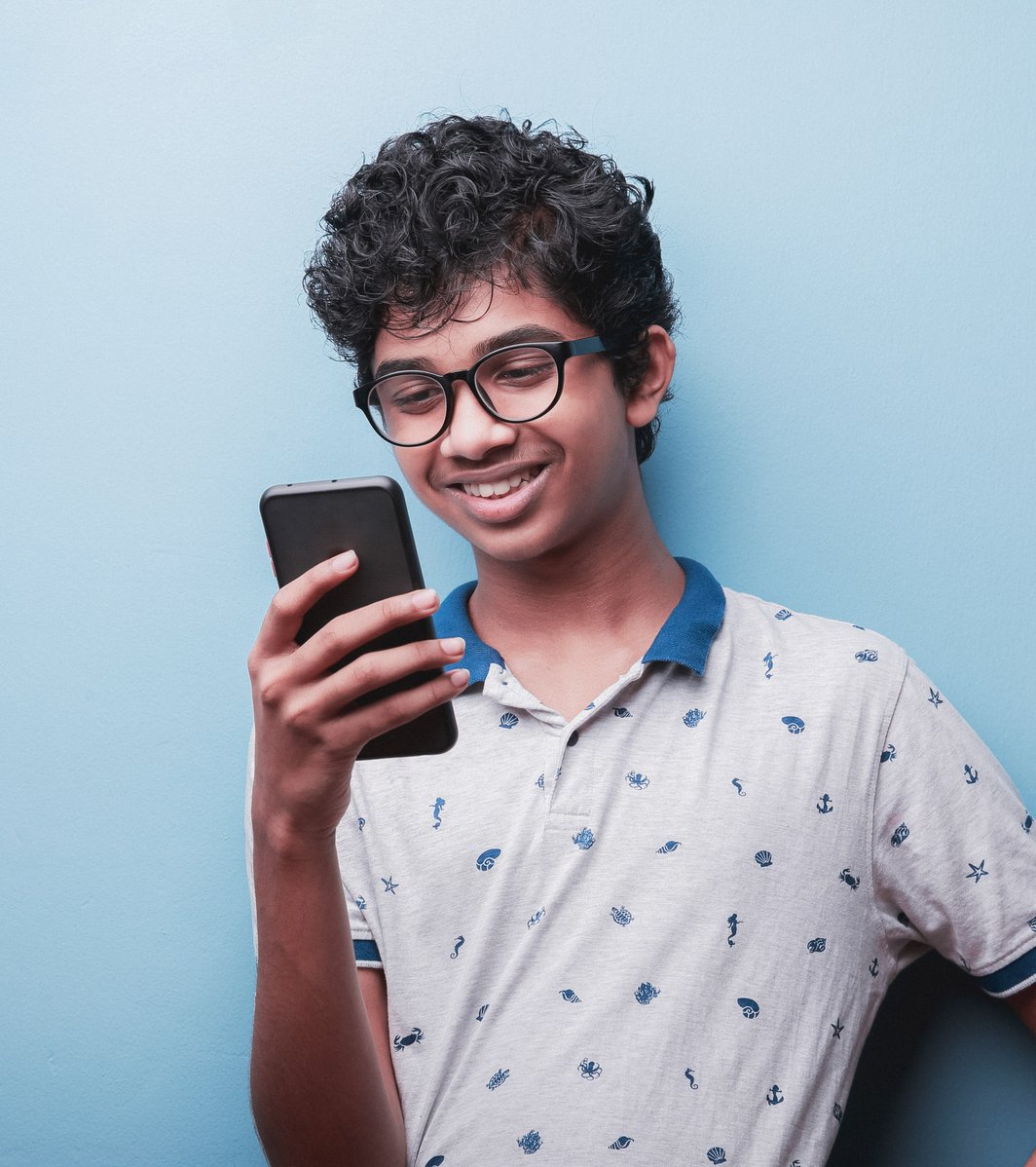 Young teen looking at his phone