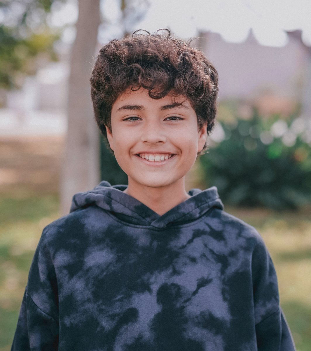 Young boy smiling outside