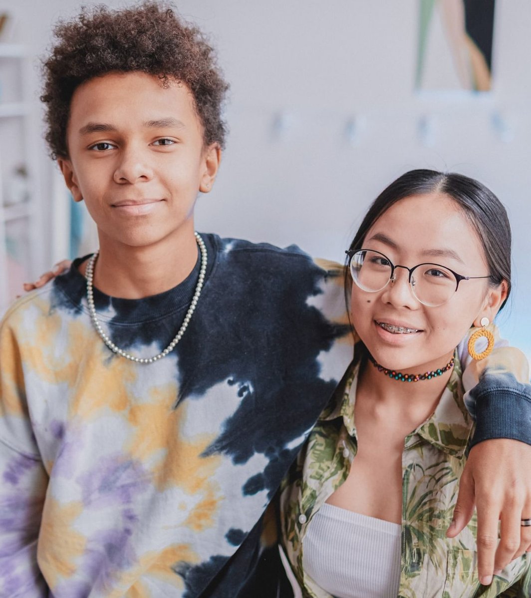 Teen boy and girl looking at the camera