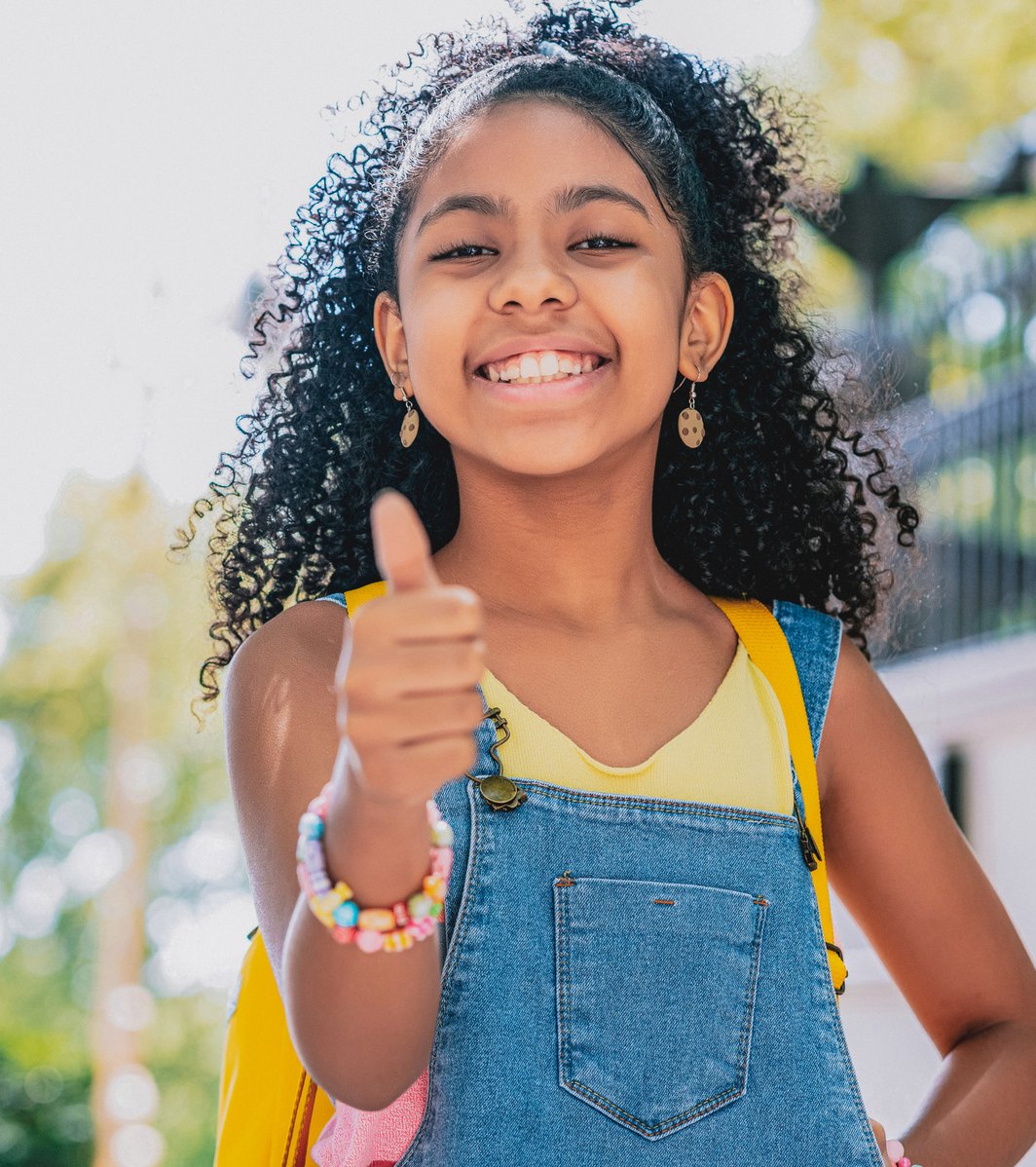 Girl giving a thumb up and smiling