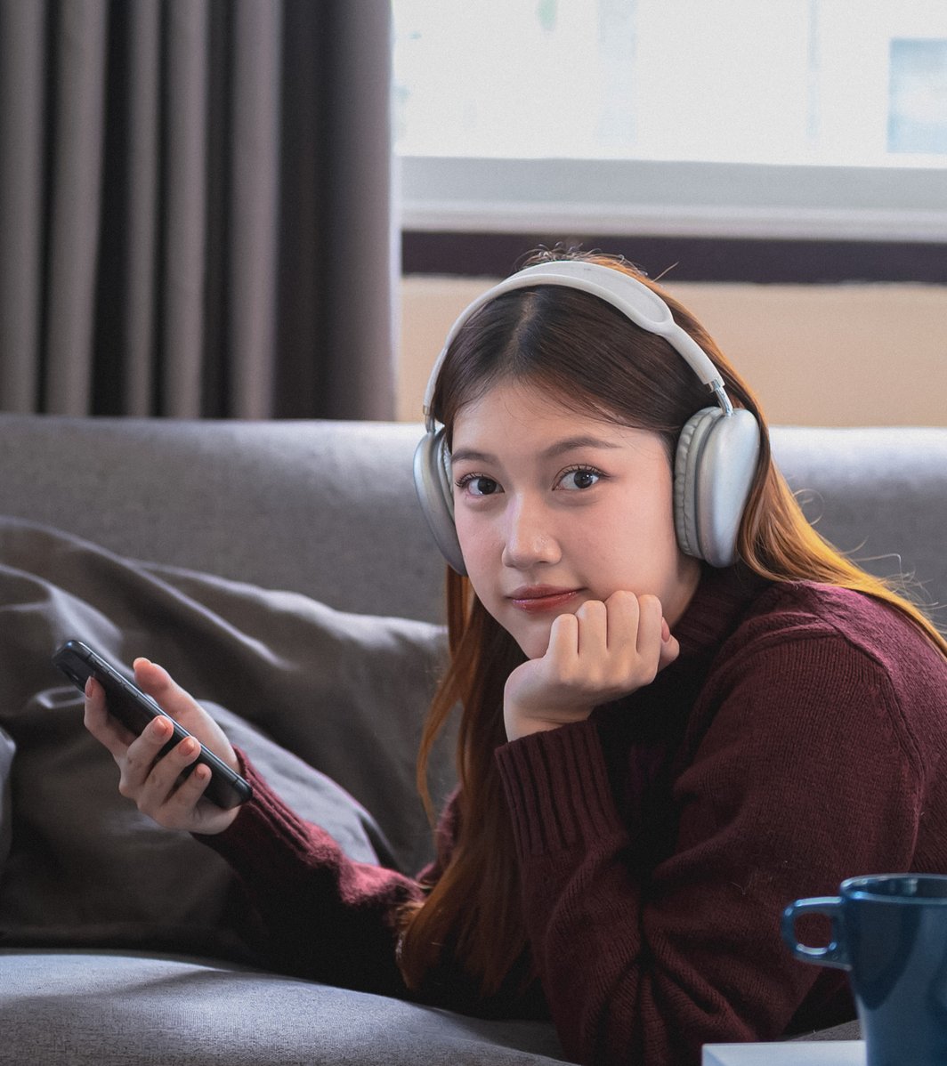 Teen girl listening to music and playing on her phone
