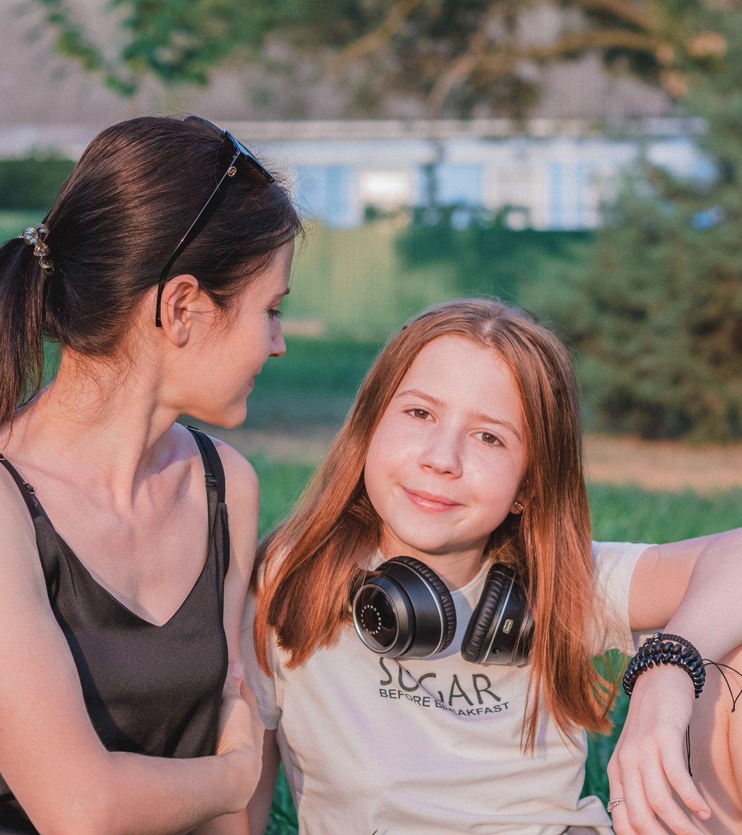 Mom and daughter relaxing in a park
