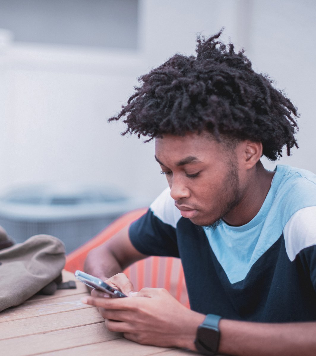 Teen kid texting on his phone