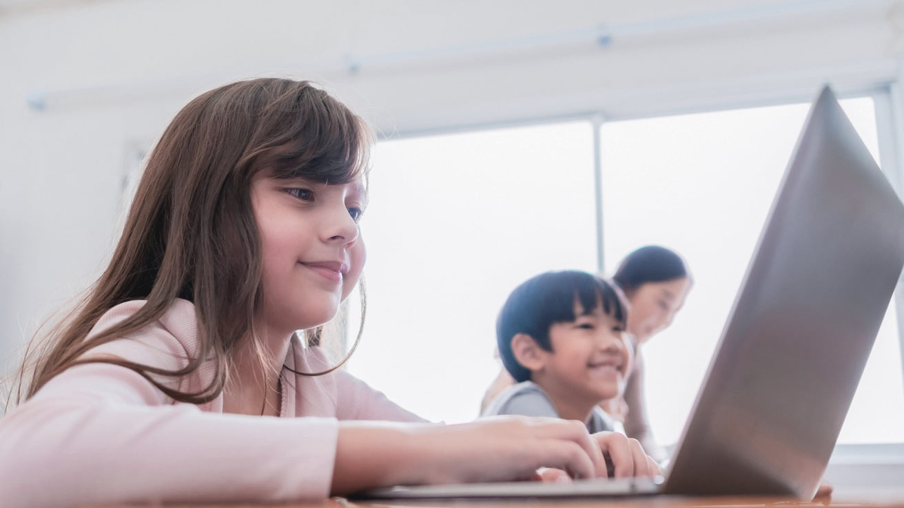 Girl in a class working on her computer