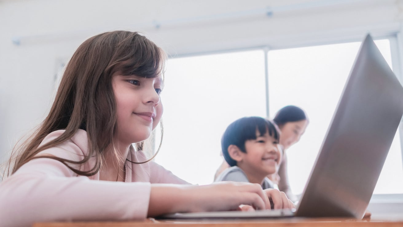 Girl in a class working on her computer