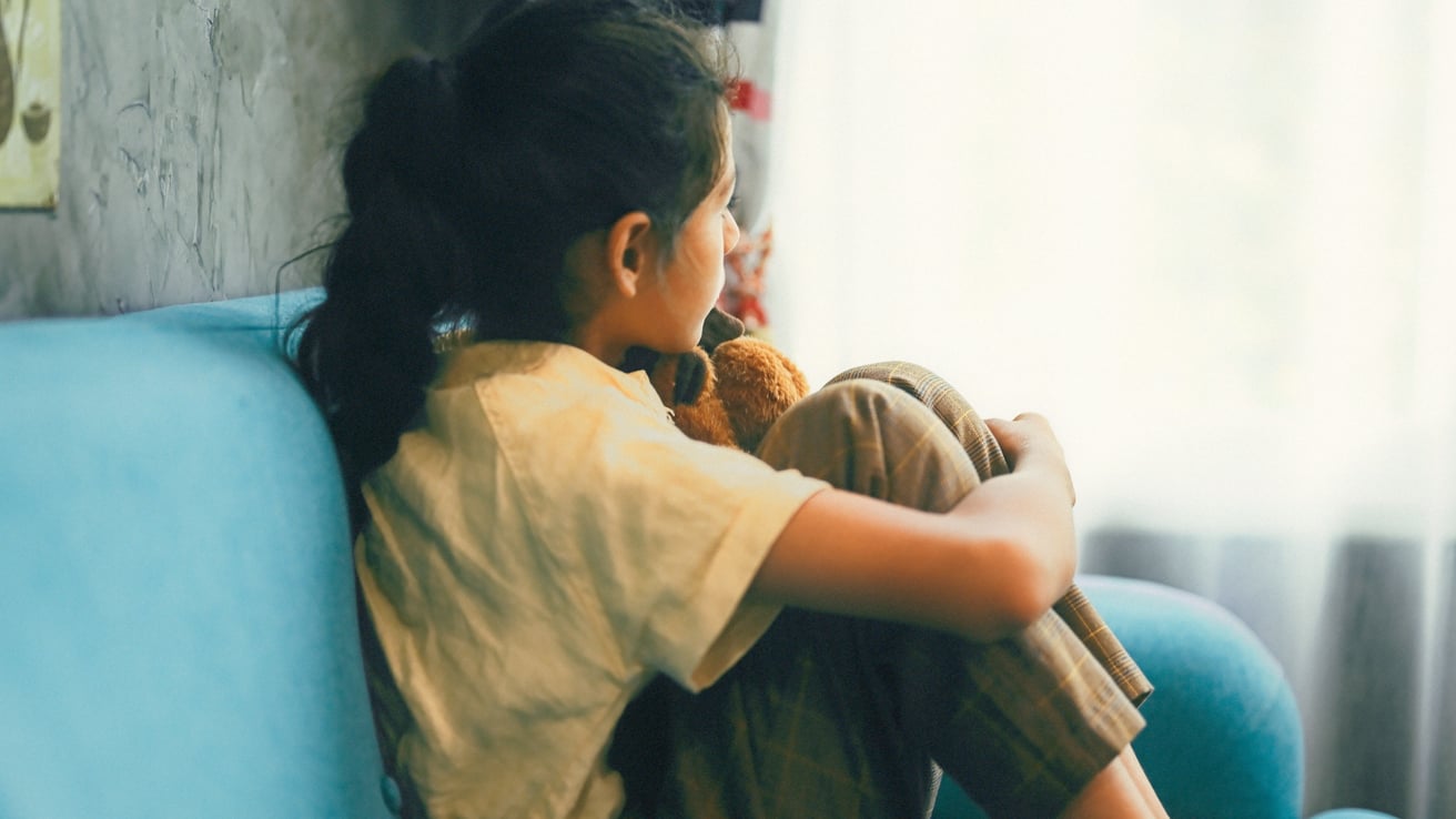 Young girl staring out the window