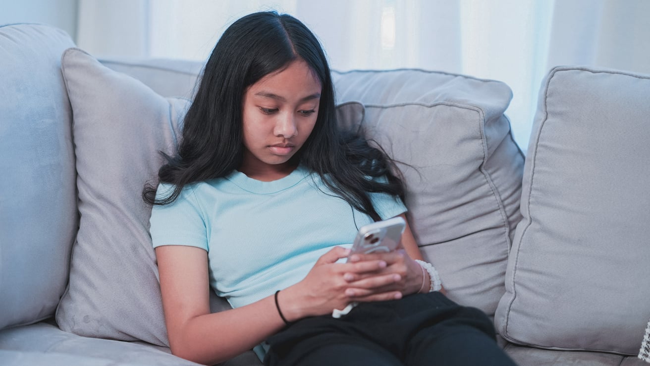 Young girl doom scrolling on her phone