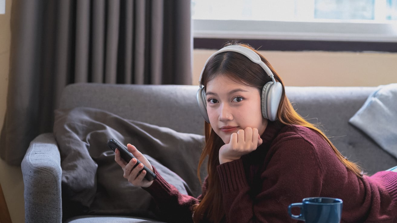 Teen girl listening to music and playing on her phone