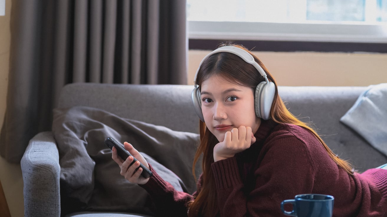 Teen girl listening to music and playing on her phone
