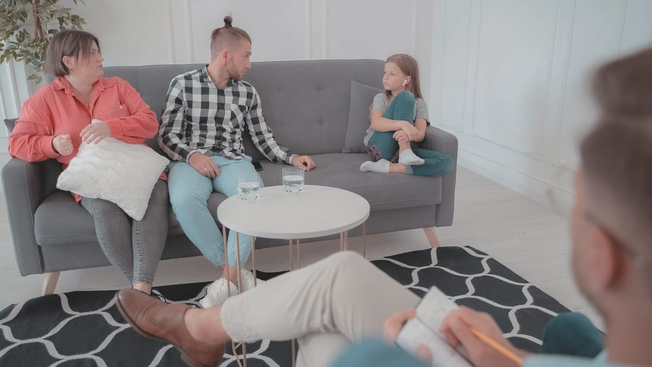 Family on a couch in a family therapy session