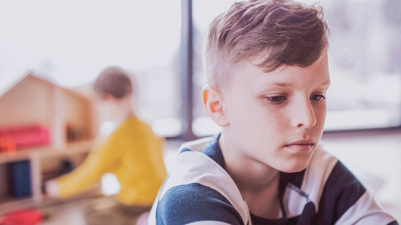 Kid dealing with trauma sitting alone