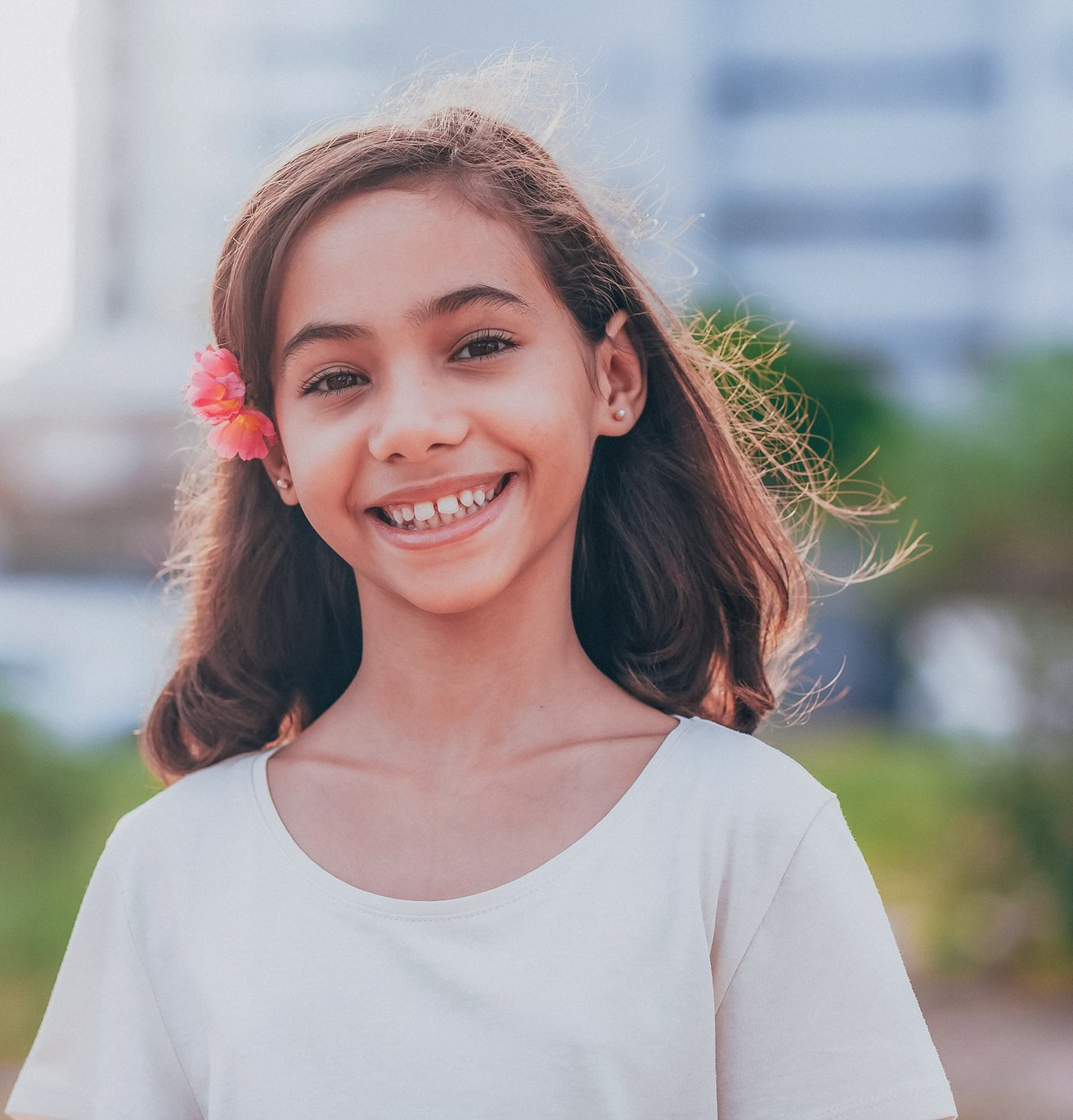 young girl smiling at camera outside