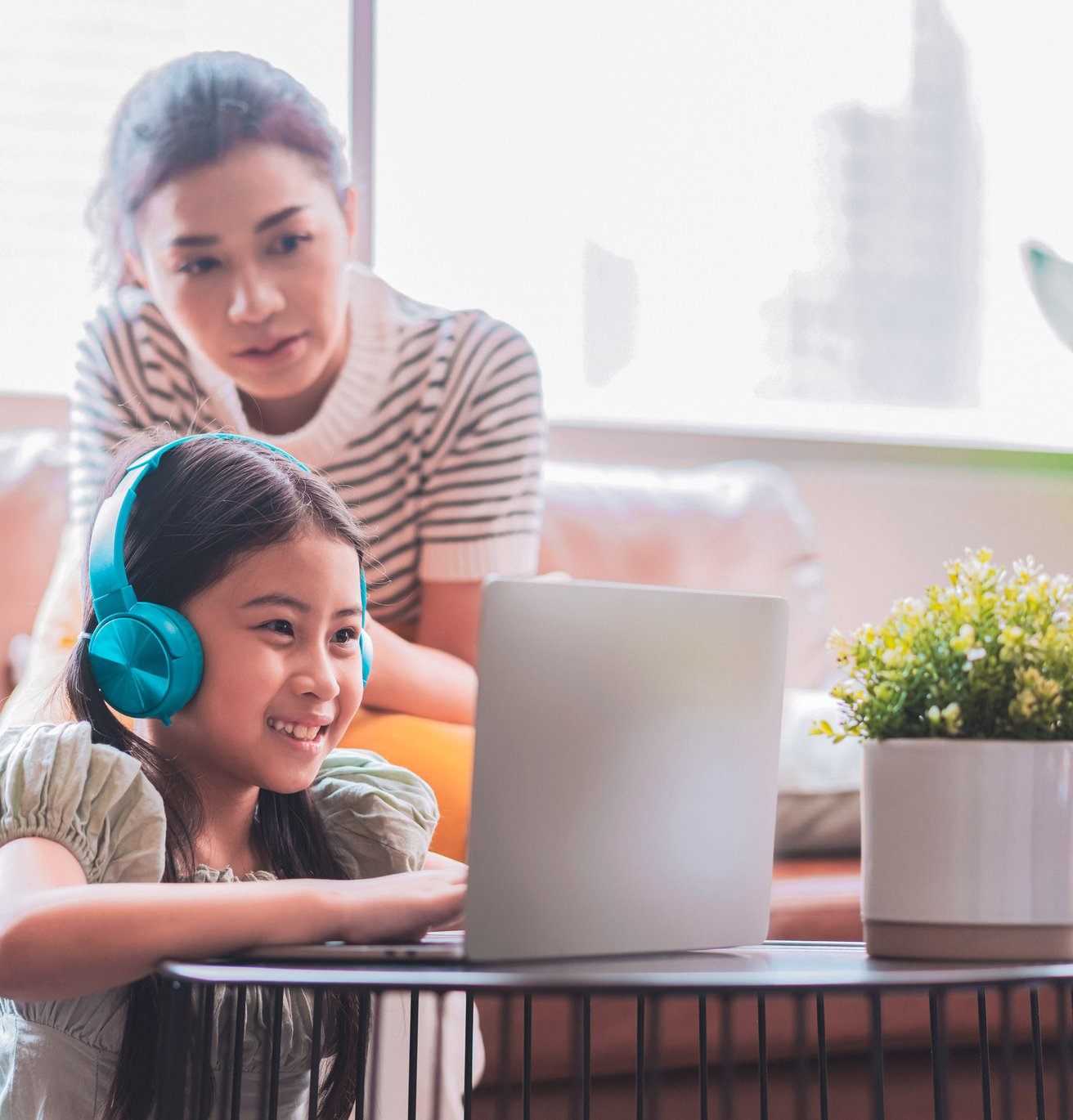 daughter smiling during therapy session in the living room and her mom is on the couch
