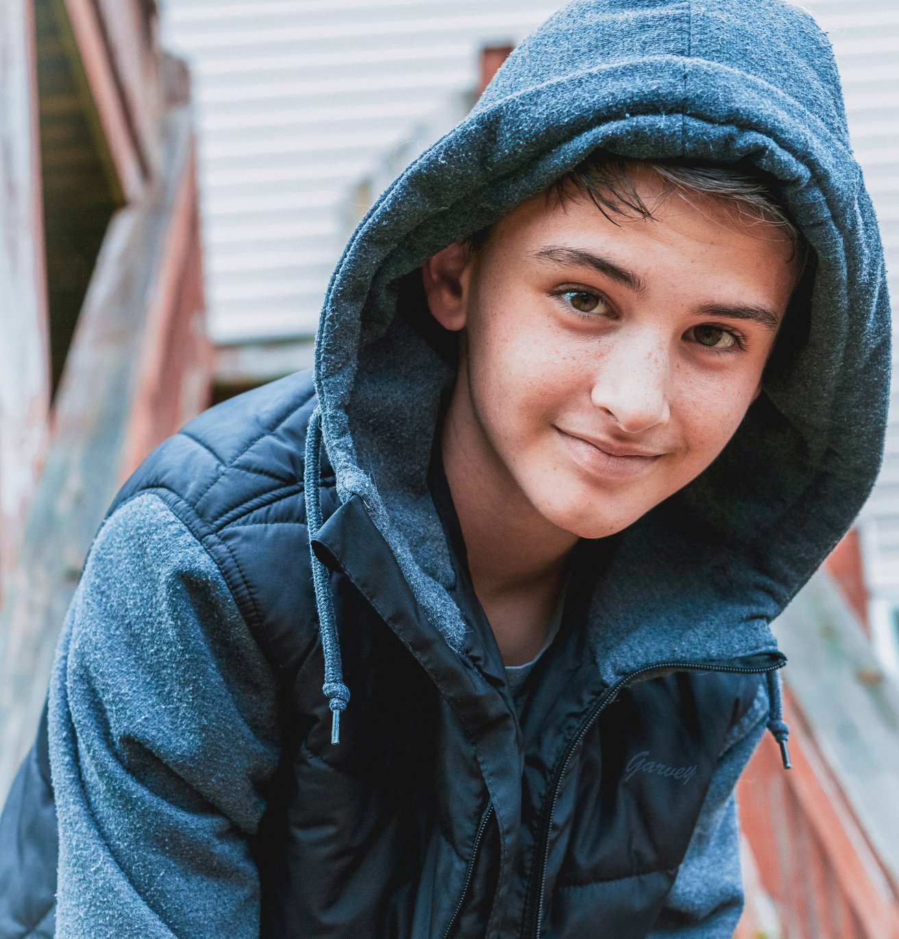 Teen boy with a hood on