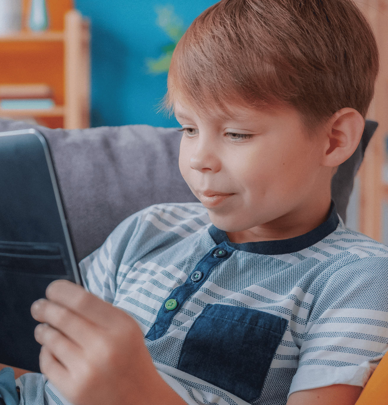 young boy smiling at computer