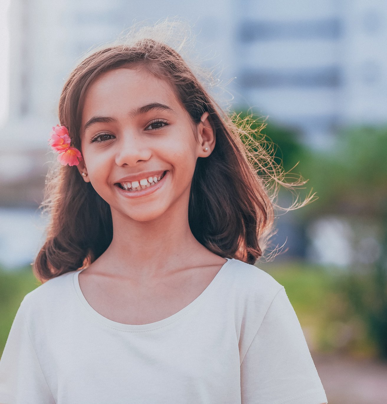 young girl smiling at camera outside