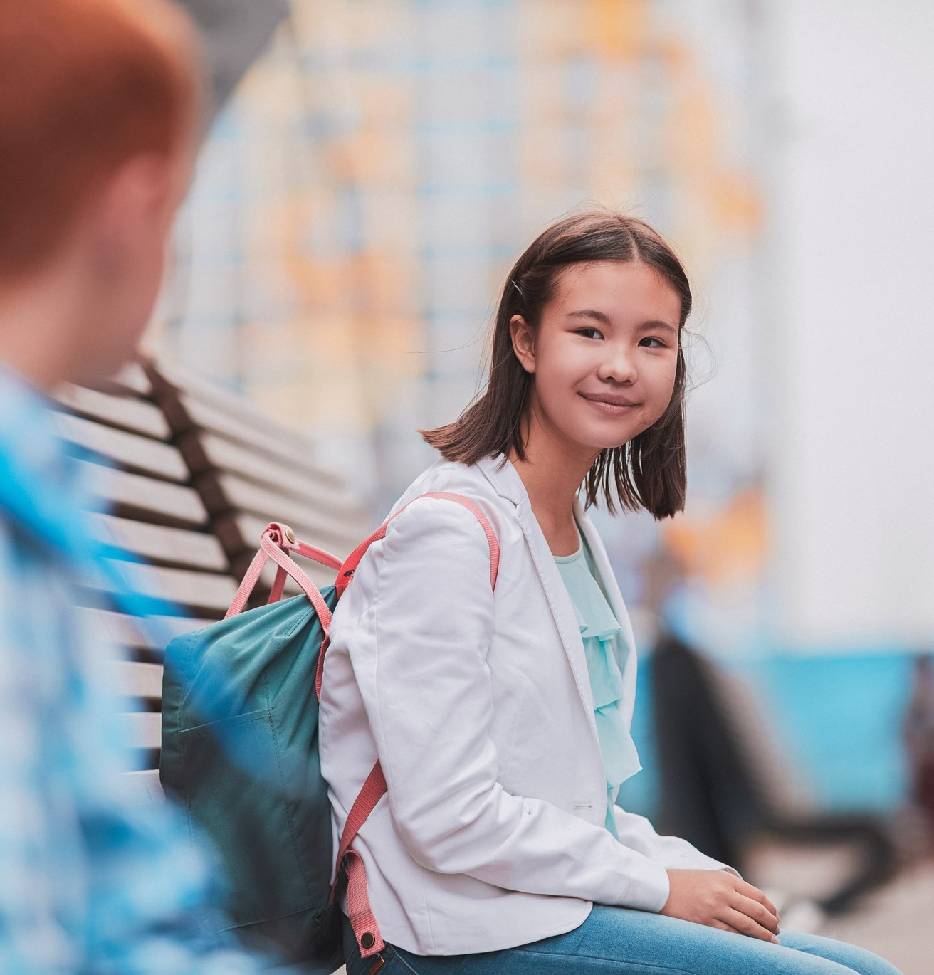 young girl smiling outside school