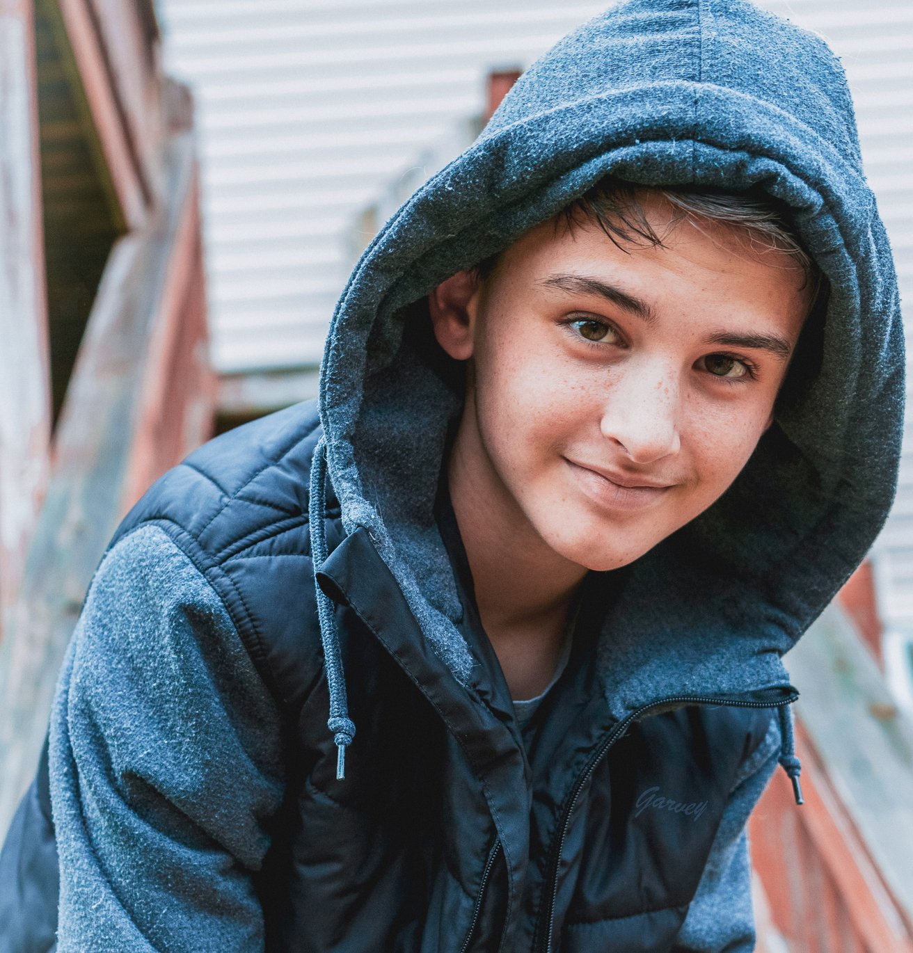 Teen boy with a hood on