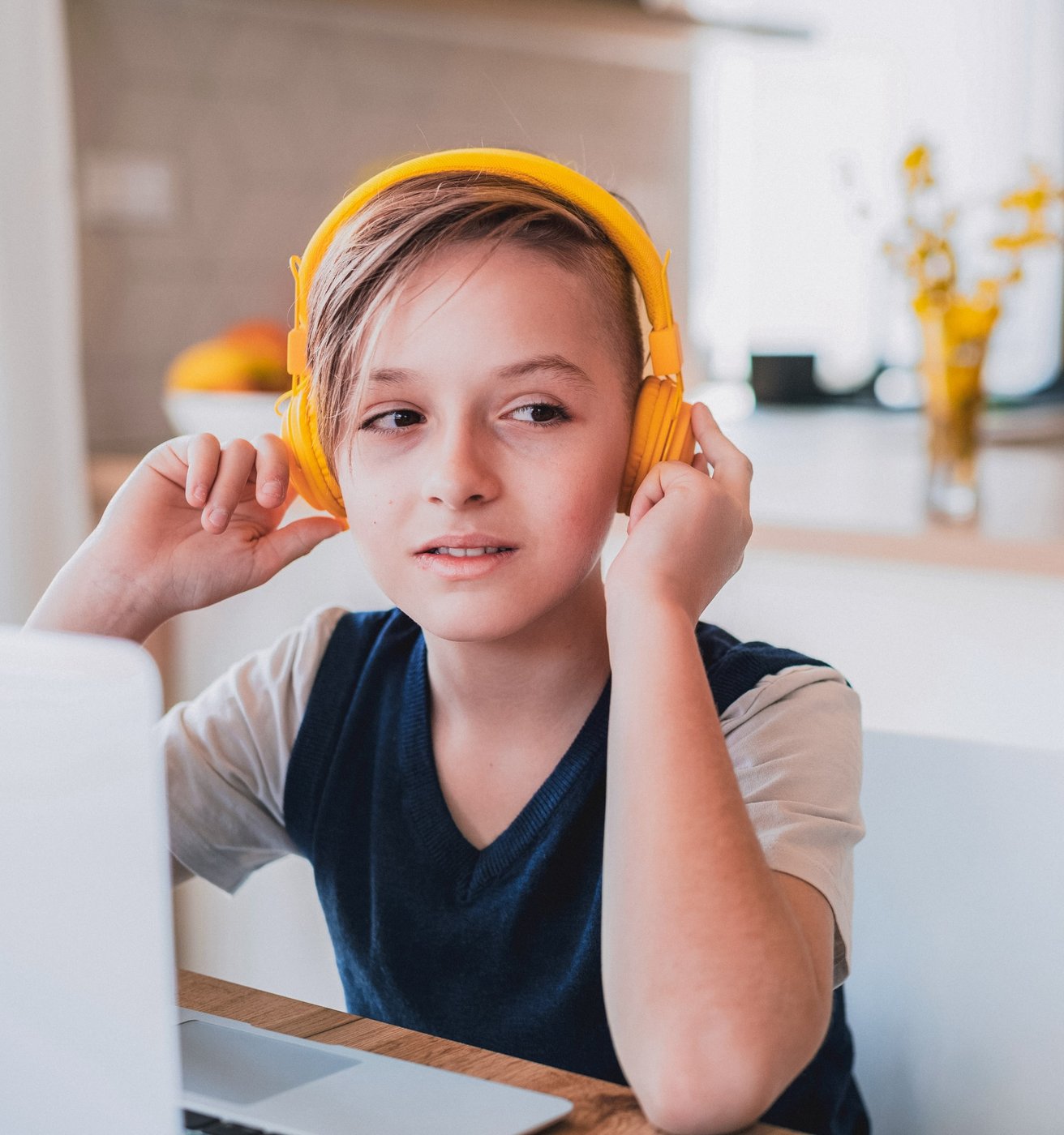 Young boy with yellow headphones on
