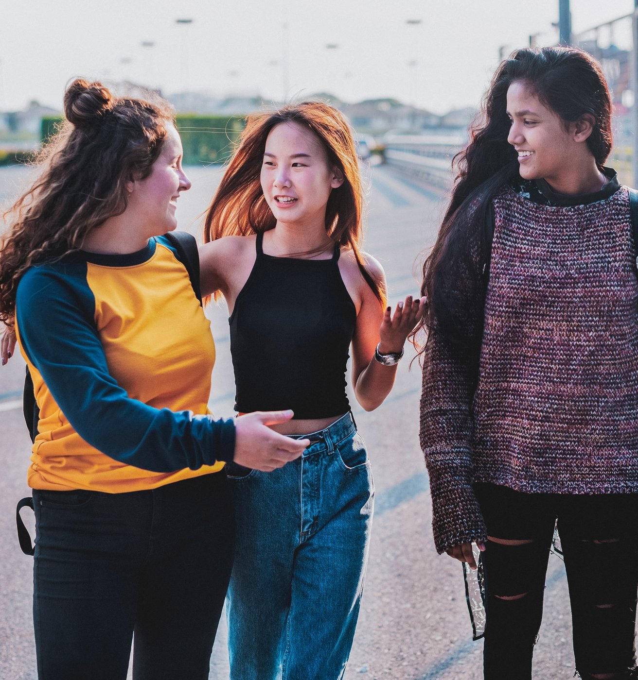 teens smiling together outside school