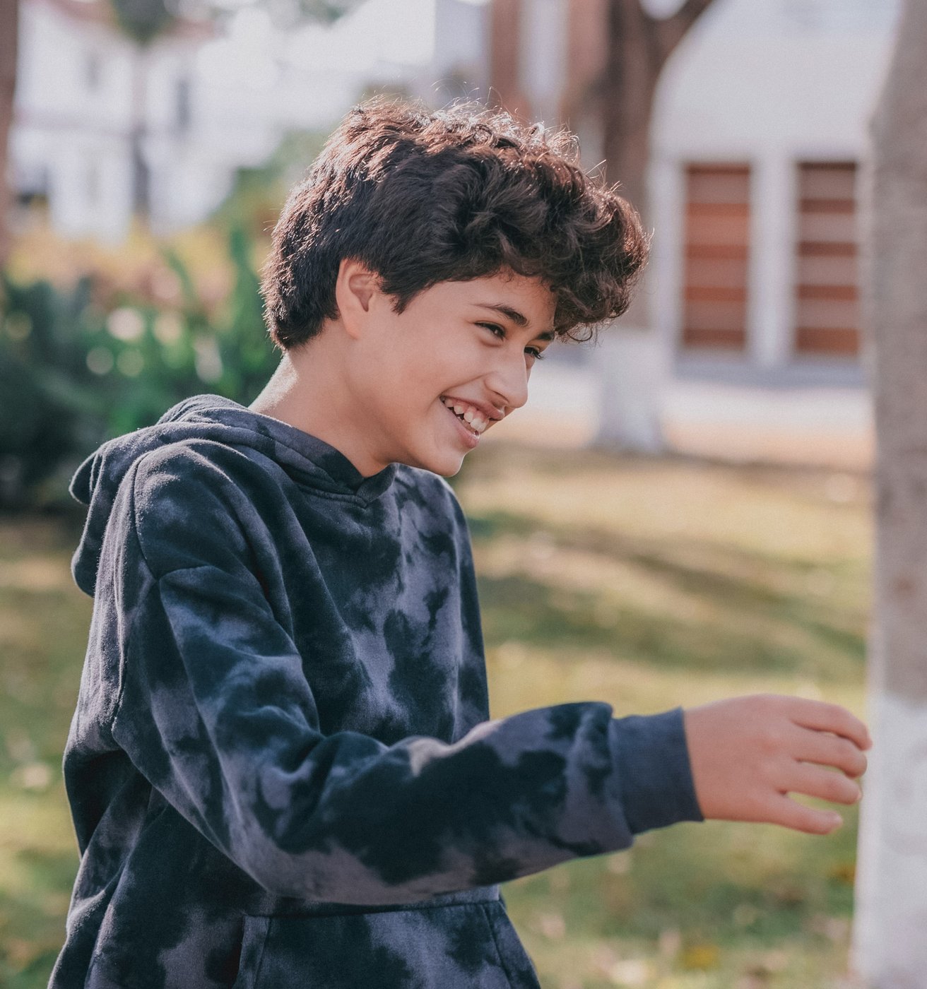 Young boy laughing outside