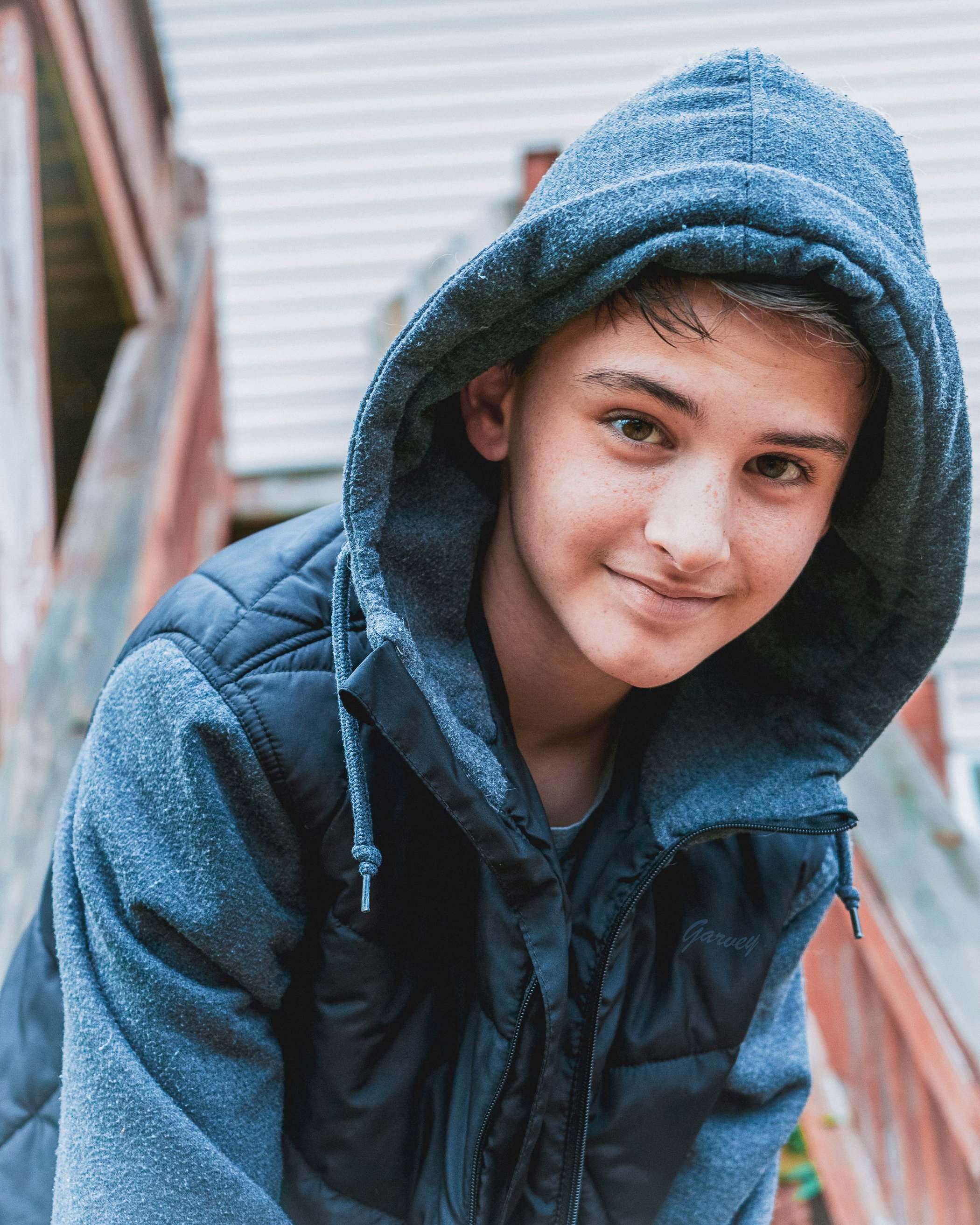 Teen boy with a hood on