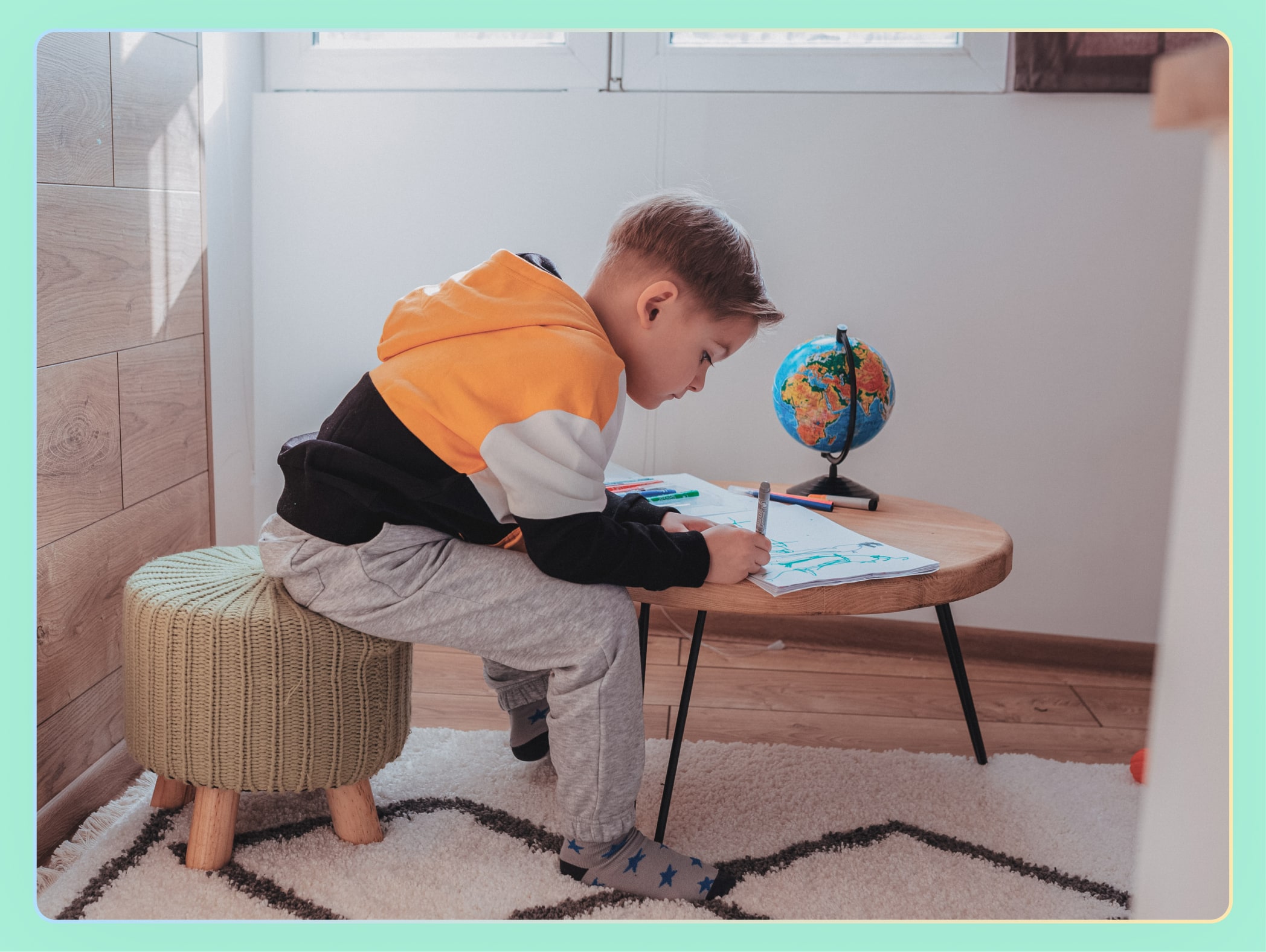 young boy drawing at home
