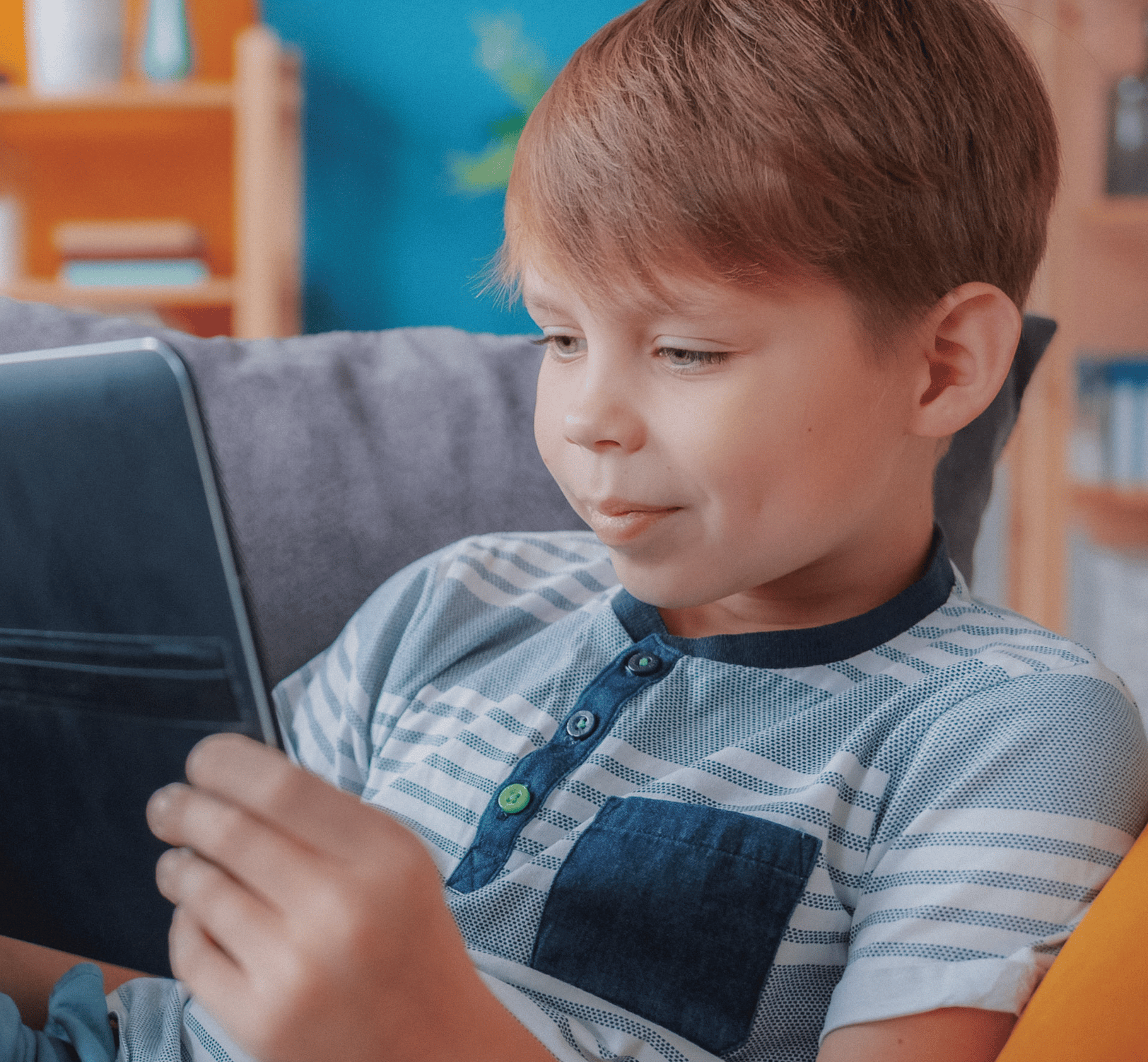 young boy smiling at computer